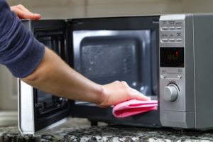 How do I clean my microwave after my kids have made a mess