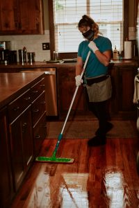 house cleaner mopping with PPE
